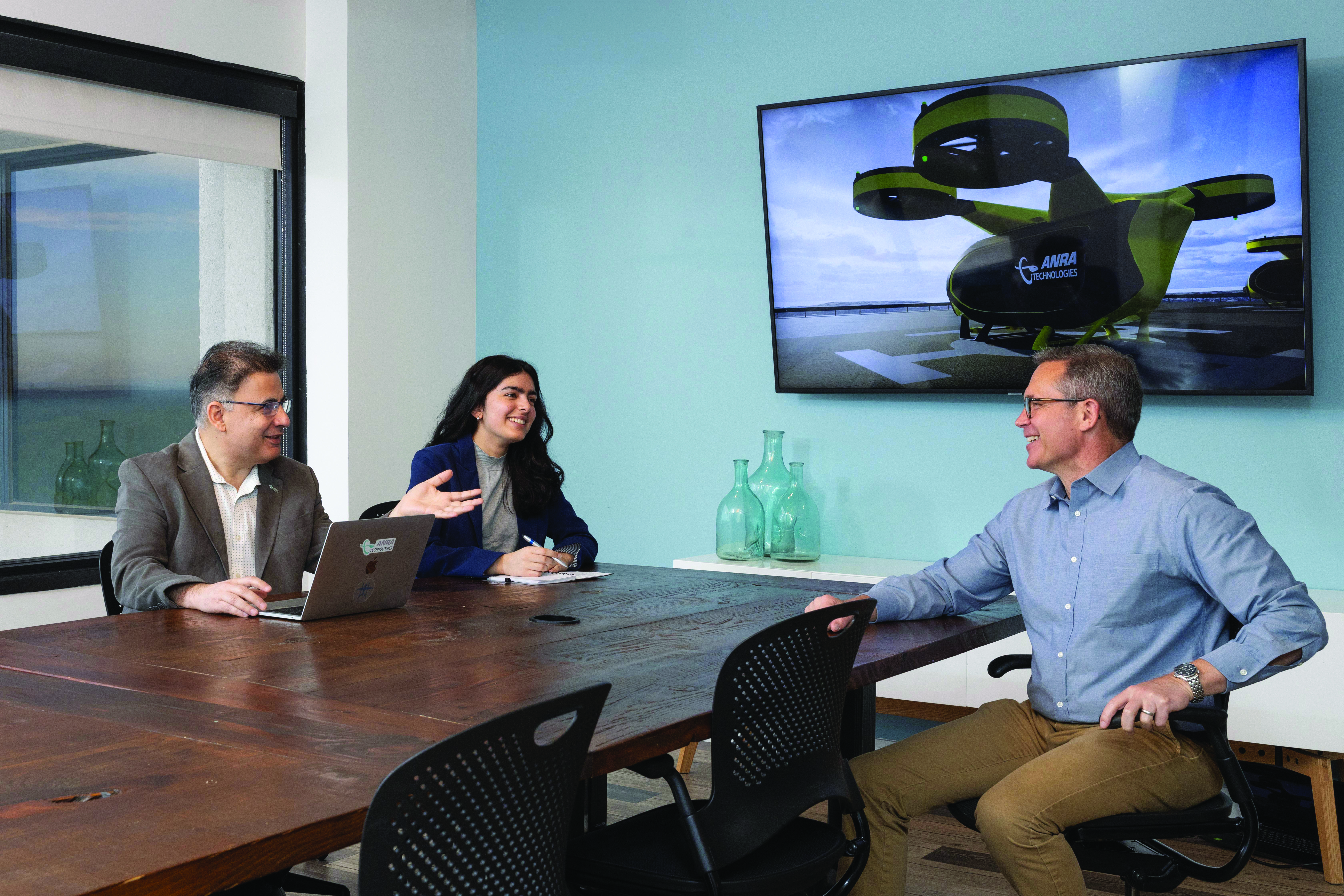 3 ANRA employees sitting at a conference table